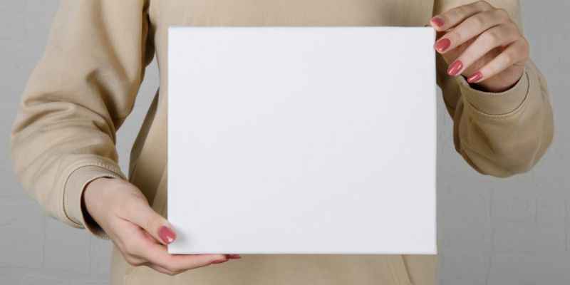 A Person Holding A Blank Canvas