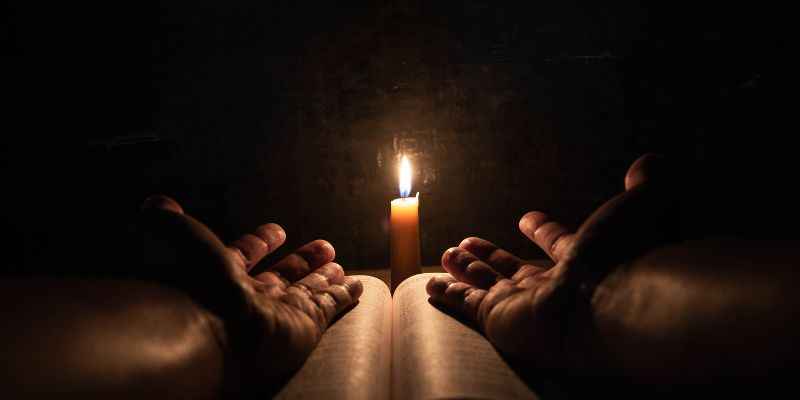 Candle Lit Prayer With a Catholic Bible