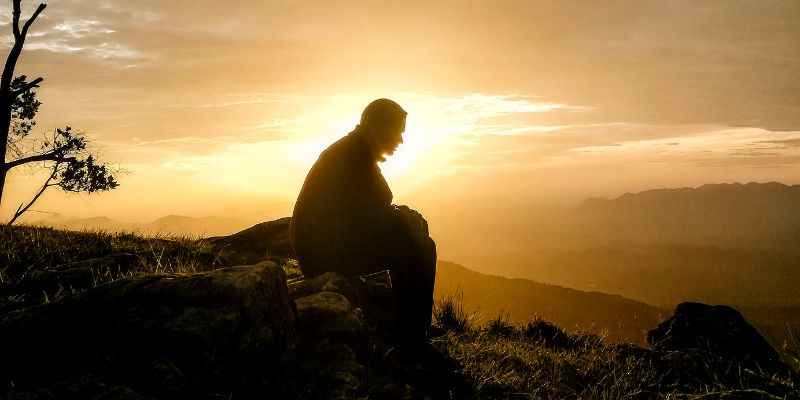 Man Sitting in Solitutde During Sunrise