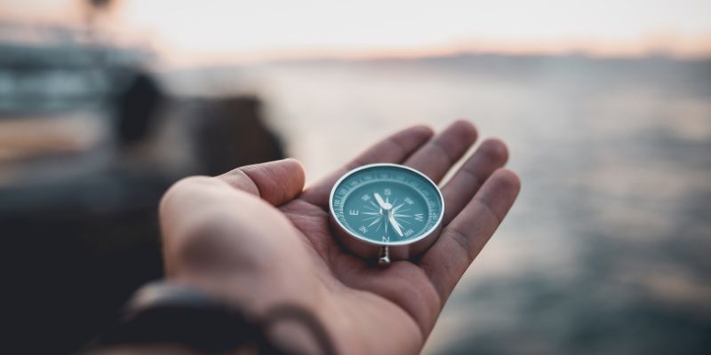 Hand Holding Compass - We lead ourselves constantly, playing a leadership role in our own lives